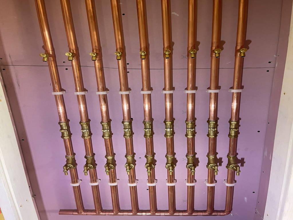 Rising Mains Cupboard 9 copper pipes on wall